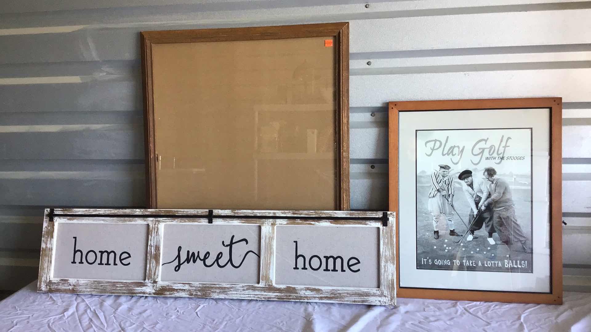 View 1 of ASSORTED WALL DECO - OAK POSTER FRAME 28” X 22”, 3 STOOGES GOLF POSTER FRAMED 22” X 18”, HOME SWEET HOME SIGN 42” X 11”