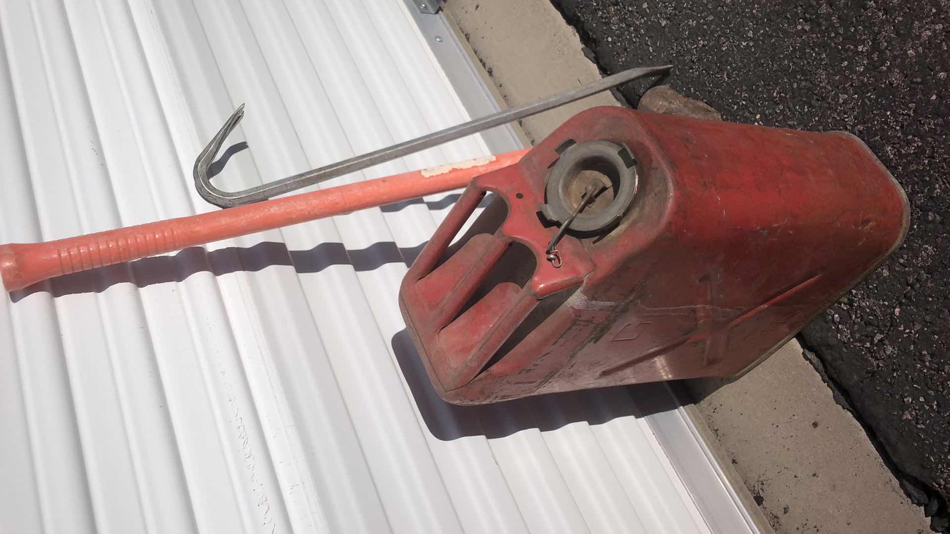 Photo 1 of HALF FULL STEEL FUEL CAN (CONTENTS UNKNOWN), CROWBAR AND SLEDGEHAMMER