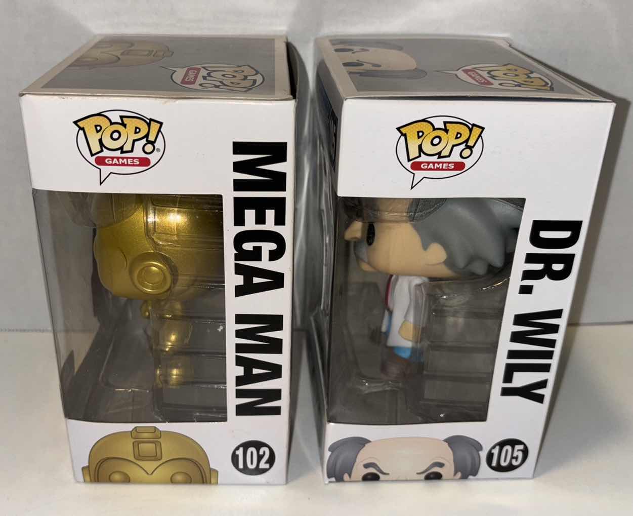 Photo 1 of NEW FUNKO POP! GAMES VINYL FIGURE, MEGAMAN 2-PACK GAMESTOP EXCLUSIVE #102 GOLD MEGA MAN ($75) & #105 DR. WILY ($12)