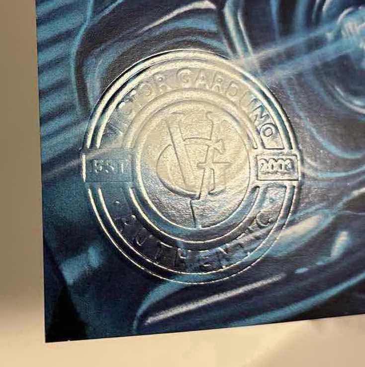Photo 1 of VICTOR GARDUNO “ELEGANT ASSASSIN” 11” X 17” INFINITY GLOSS UNFRAMED PRINT W EMBOSSED SEAL, DIGITAL SIGNATURE & OFFICIAL SIGNATURE W COA INCLUDED, STORED IN A RIGID PRINT PROTECTOR SLEEVE