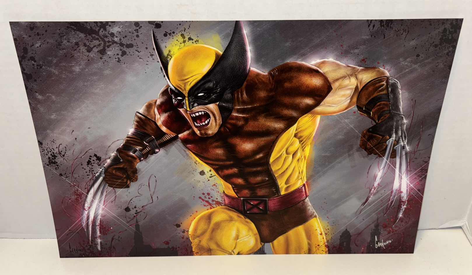 View 1 of VICTOR GARDUNO WOLVERINE IN BROWN SUIT 11” X 17” INFINITY GLOSS UNFRAMED PRINT W EMBOSSED SEAL, DIGITAL SIGNATURE & OFFICIAL SIGNATURE W COA INCLUDED, STORED IN A RIGID PRINT PROTECTOR SLEEVE
