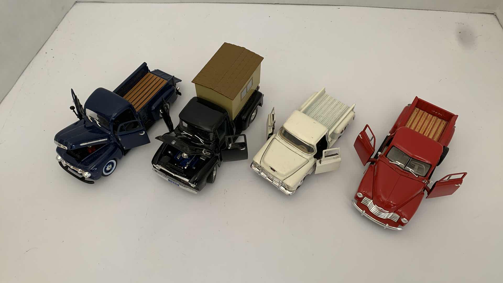 Photo 1 of SET OF 4 DIE CAST METAL FORD AND CHEVORLET TRUCKS 6” X 2” H 3”