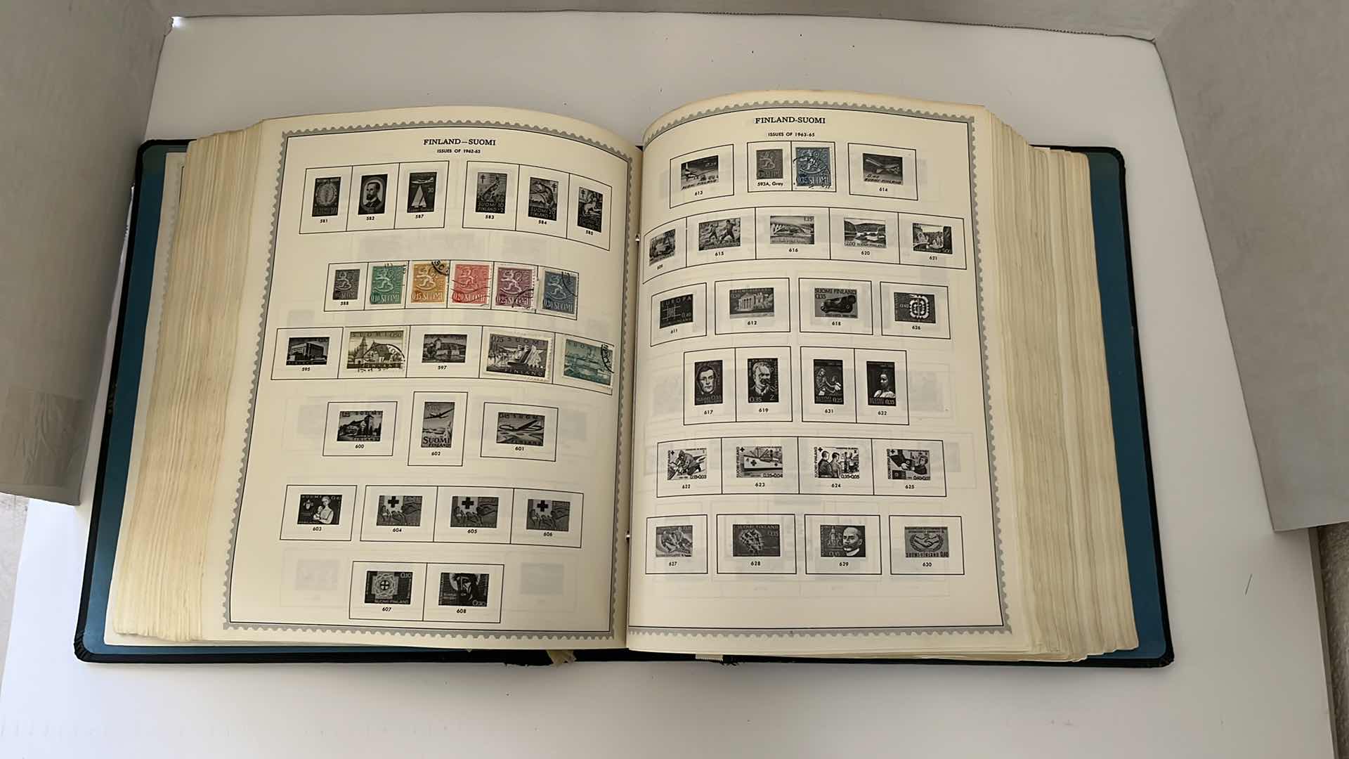 Photo 1 of GLOBAL STAMP ALBUM CONTAINING VINTAGE STAMPS