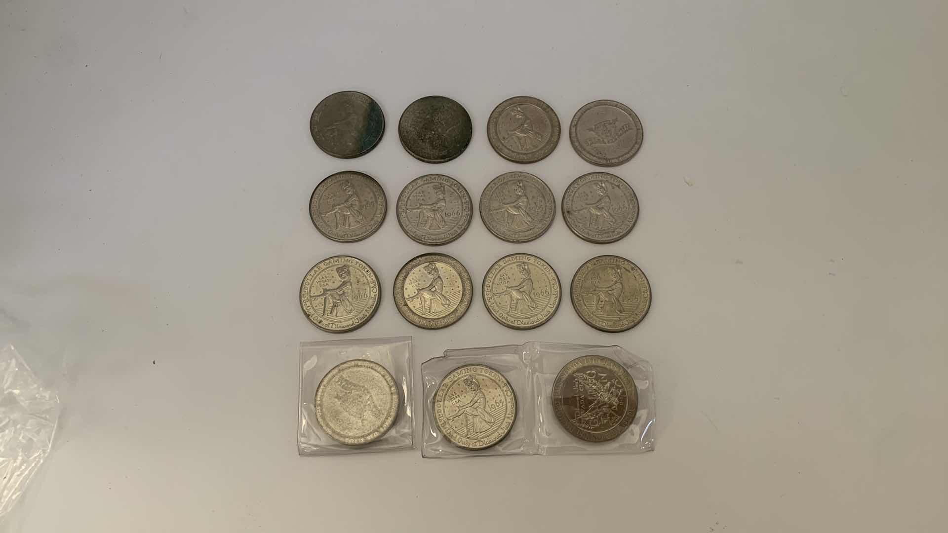 Photo 1 of 15- VINTAGE GAMING TOKENS - 13- ONE DOLLAR 1967 DIAMOND JOMS, 2 WHISKEY PETES