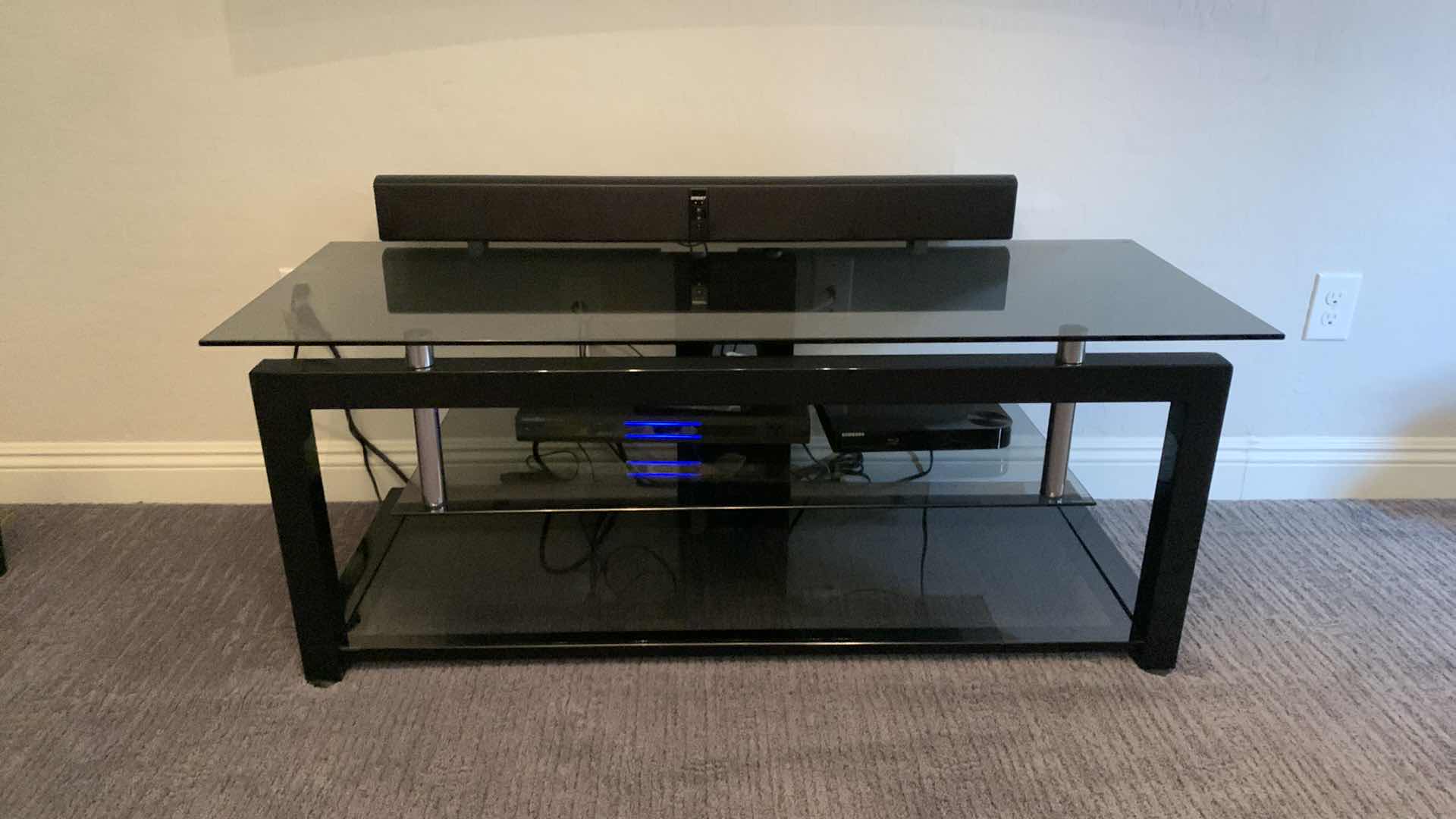 Photo 1 of BLACK TEMPERED SMOKED GLASS W CHROME ENTERTAINMENT CONSOLE (ELECTRONICS OR SOUNDBAR NOT INCLUDED) 52” x 20” x H20”