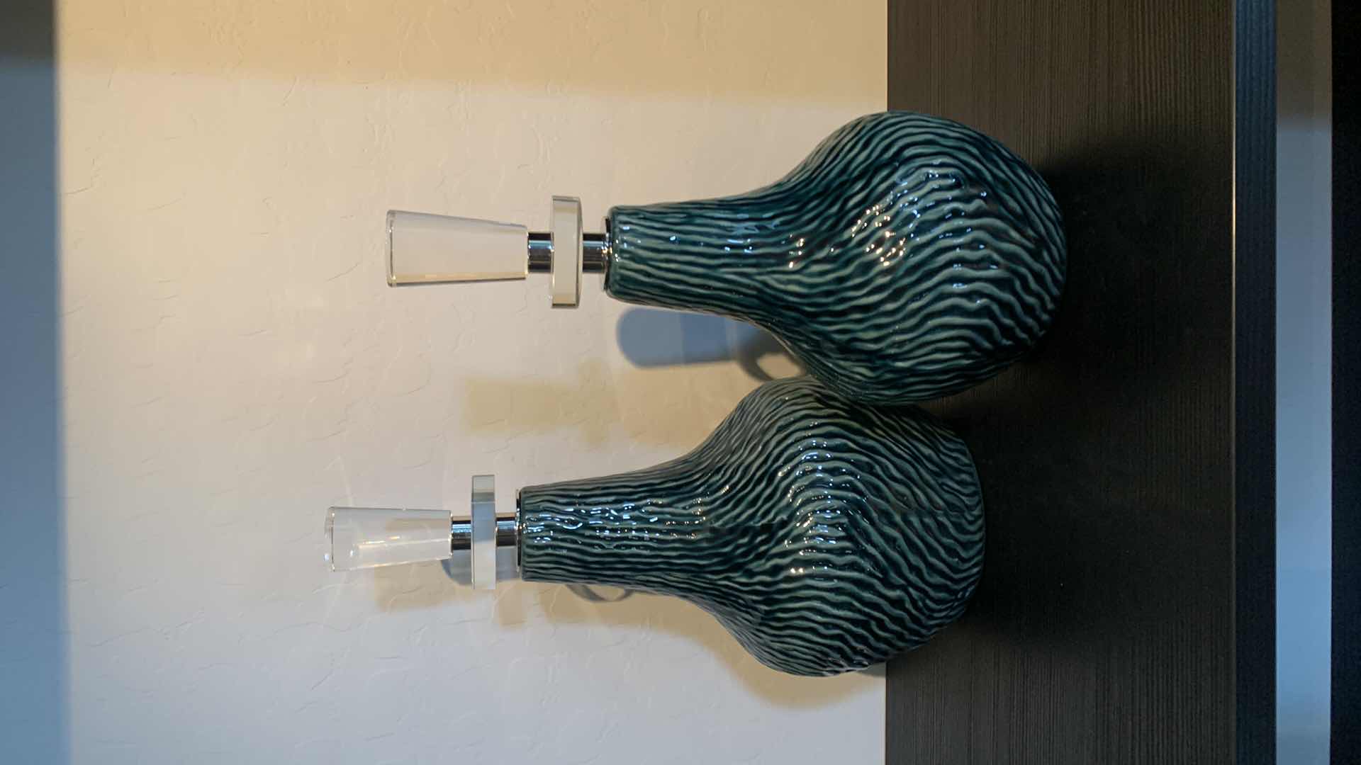Photo 1 of 2- UTTERMOST ALMERA CERAMIC BOTTLES W DARK TEAL GLAZE POLISH NICKEL W THICK CRYSTAL DETAILS H15.5” & 13.5”