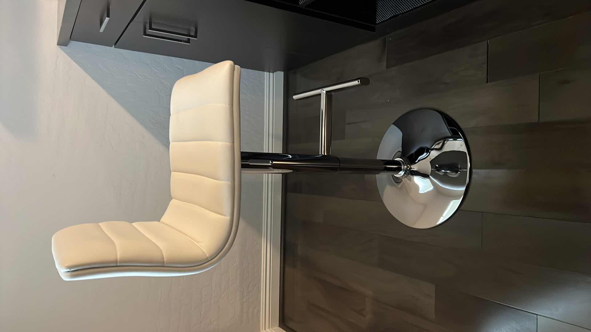 Photo 1 of DESIGNER WHITE LEATHER ADJUSTABLE ARMLESS SWIVEL UP AMD DOWN BAR STOOL W SILVER BASE