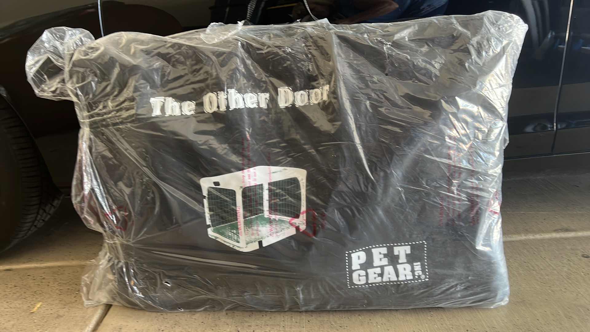 Photo 1 of NEW PET GEAR "THE OTHER DOOR" 4 DOOR STEEL CRATE W GARAGE-STYLE DOOR, PLUSH BED, TRAVEL BAG-NO TOOLS REQUIRED