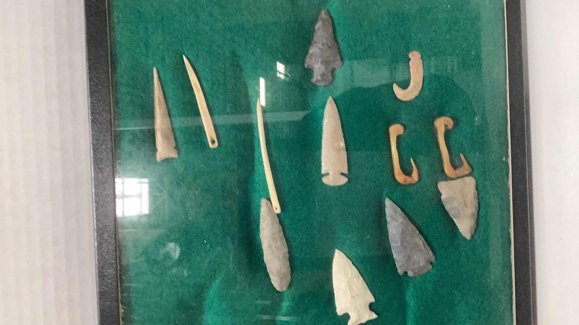Photo 1 of RARE ANTIQUE NAVAHO MISCELLANEOUS HUNTING ITEMS. CIRCA 1600 B.C. ARROWHEADS, NEEDLES, AND FISH HOOKS CASE 12” X 17”