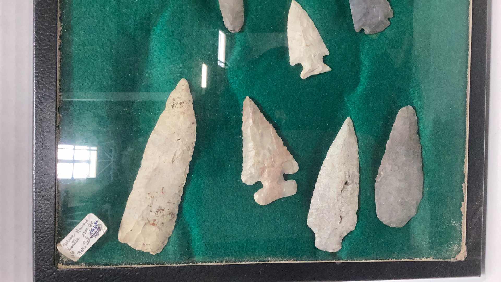 Photo 1 of RARE ANTIQUE NAVAHO MISCELLANEOUS HUNTING ITEMS. CIRCA 1600 B.C. ARROWHEADS, NEEDLES, AND FISH HOOKS CASE 12” X 17”