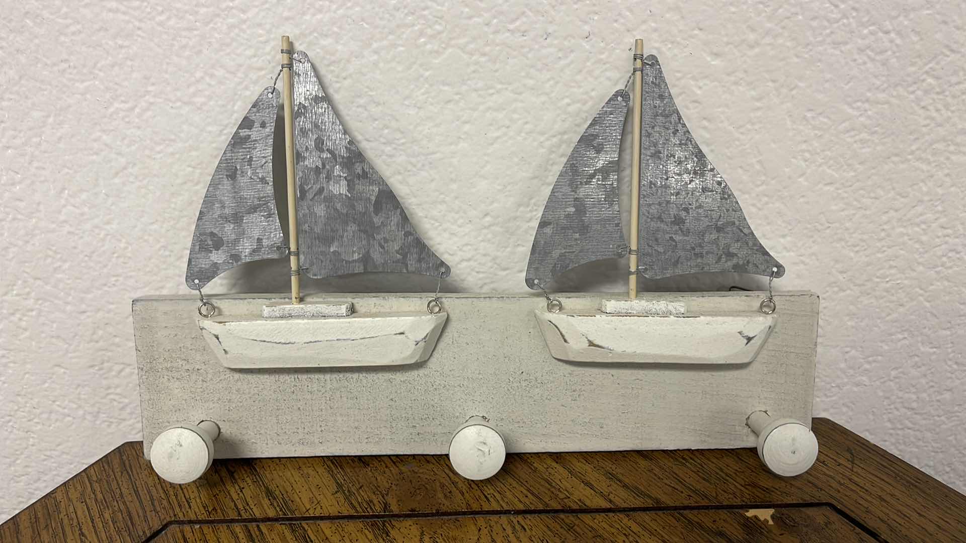 Photo 1 of WOOD BASE COAT HANGER W MEDAL SAILS 12” X 7”