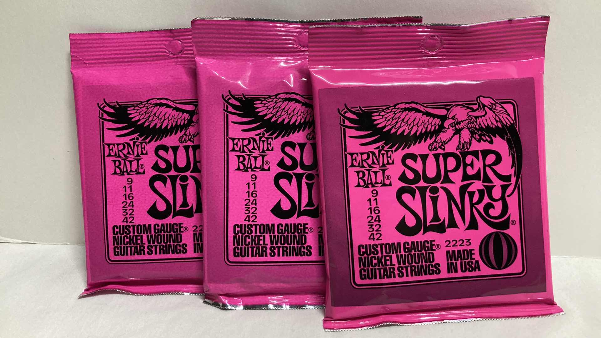 Photo 1 of NEW ERNIE BALL CUSTOM GAUGE NICKEL WOUND GUITAR STRINGS MULTI PACK (12)