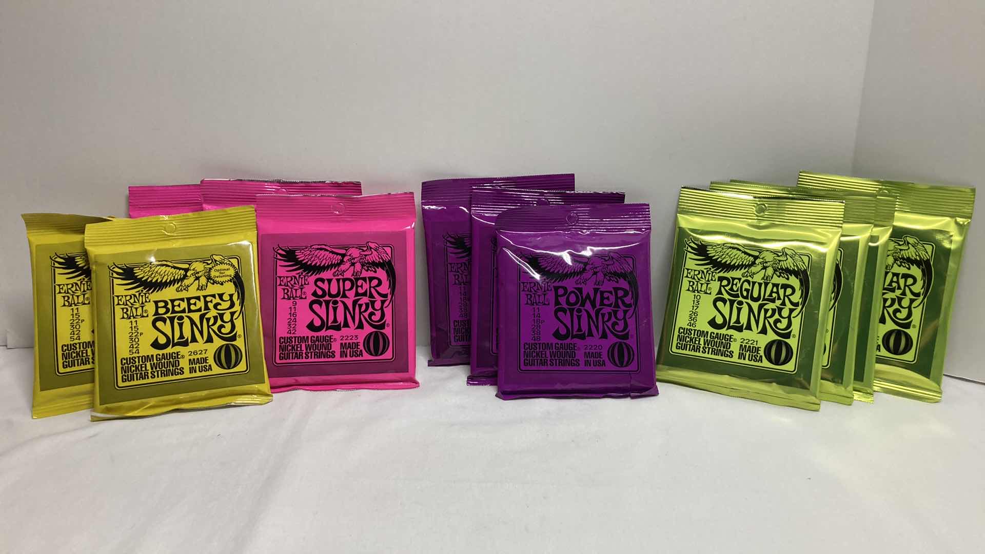 Photo 1 of NEW ERNIE BALL CUSTOM GAUGE NICKEL WOUND GUITAR STRINGS MULTI PACK (12)