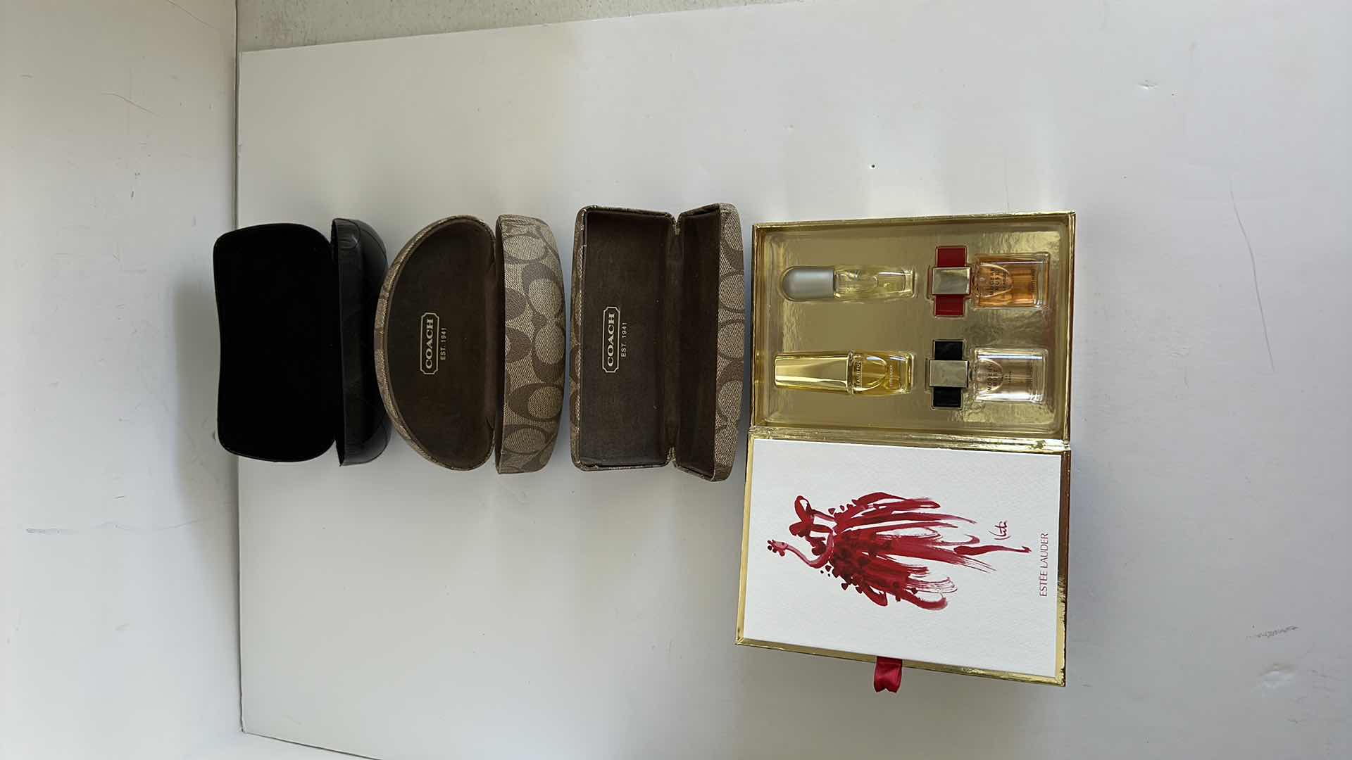 Photo 1 of CHANEL AND COACH GLASS CASES AND ESTE LAUDER PERFUME SAMPLER