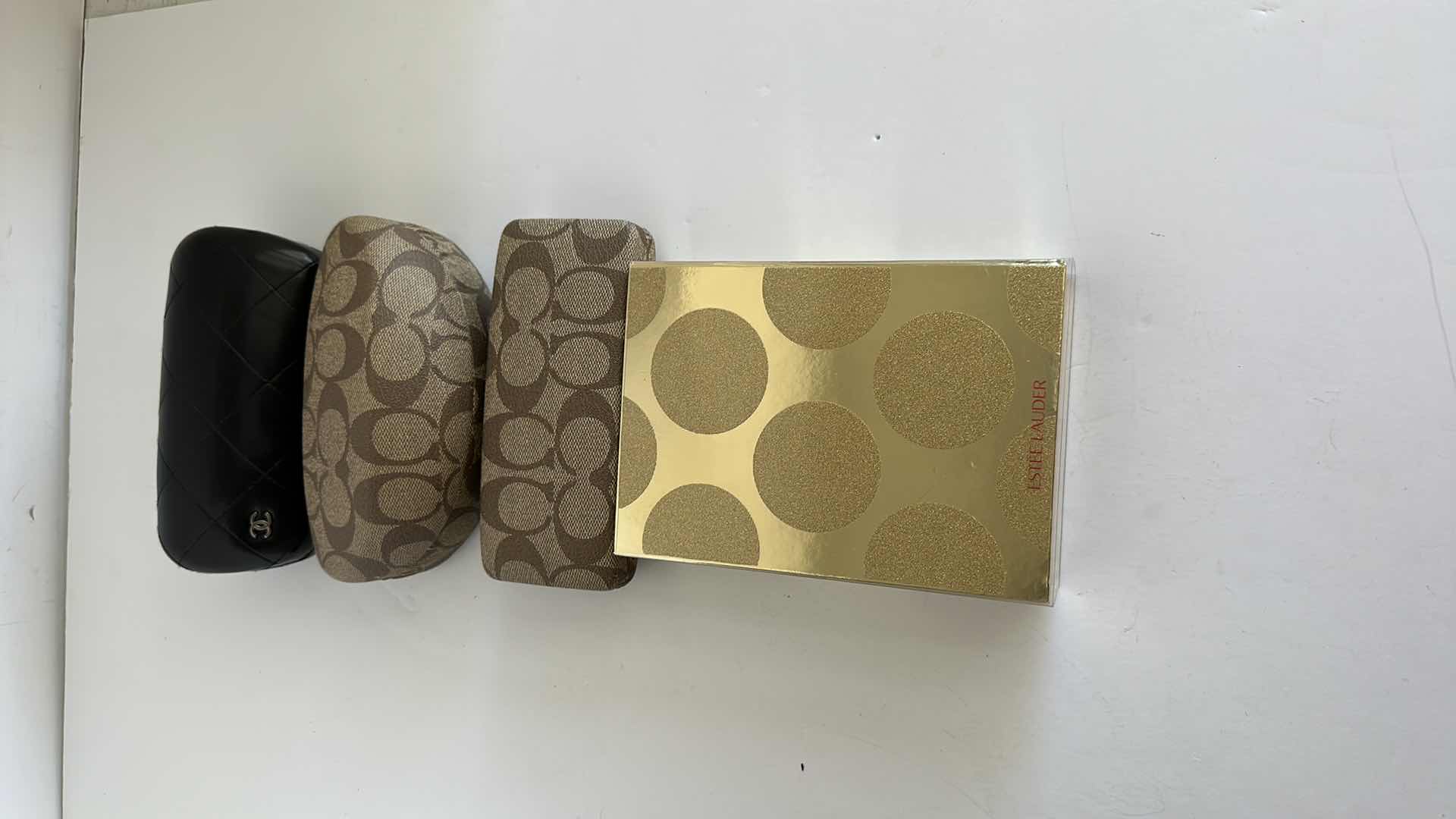 Photo 1 of CHANEL AND COACH GLASS CASES AND ESTE LAUDER PERFUME SAMPLER