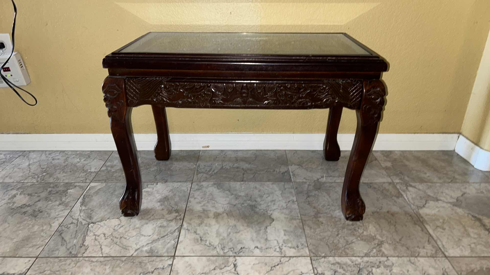 Photo 1 of CARVED WOOD TABLE WITH GLASS TOP, 24” x 13” H16.5”