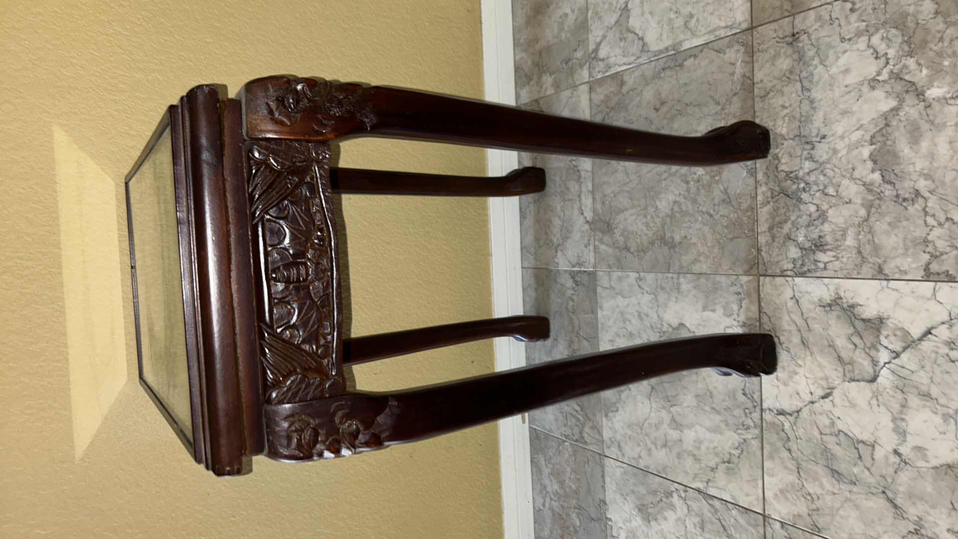 Photo 1 of CARVED WOOD TABLE WITH GLASS TOP, 19” x 12” H27”