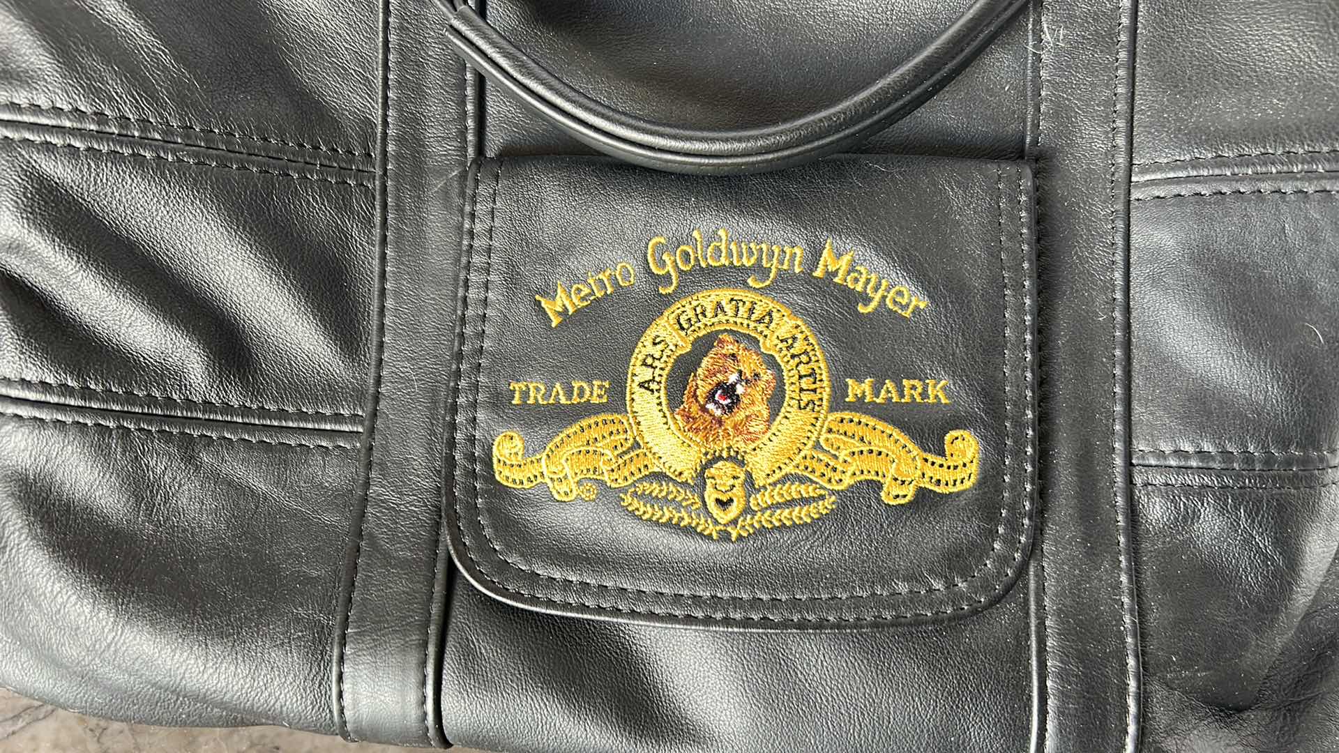 Photo 1 of METRO GOLDWYN MAYER EMBROIDERED GENUINE LEATHER TRAVEL BAG