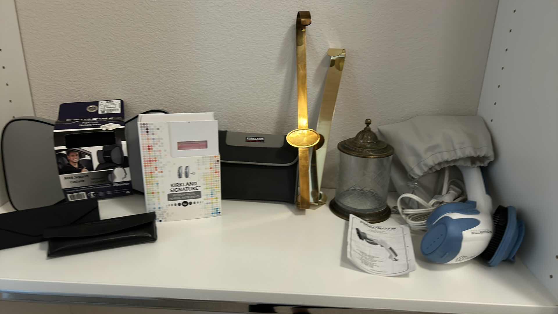 Photo 1 of CONTENTS OF SHELF (HEARING AIDS AND CLEANER NECK CUSHION ROWENTA ULTRA STEAM AND MORE)