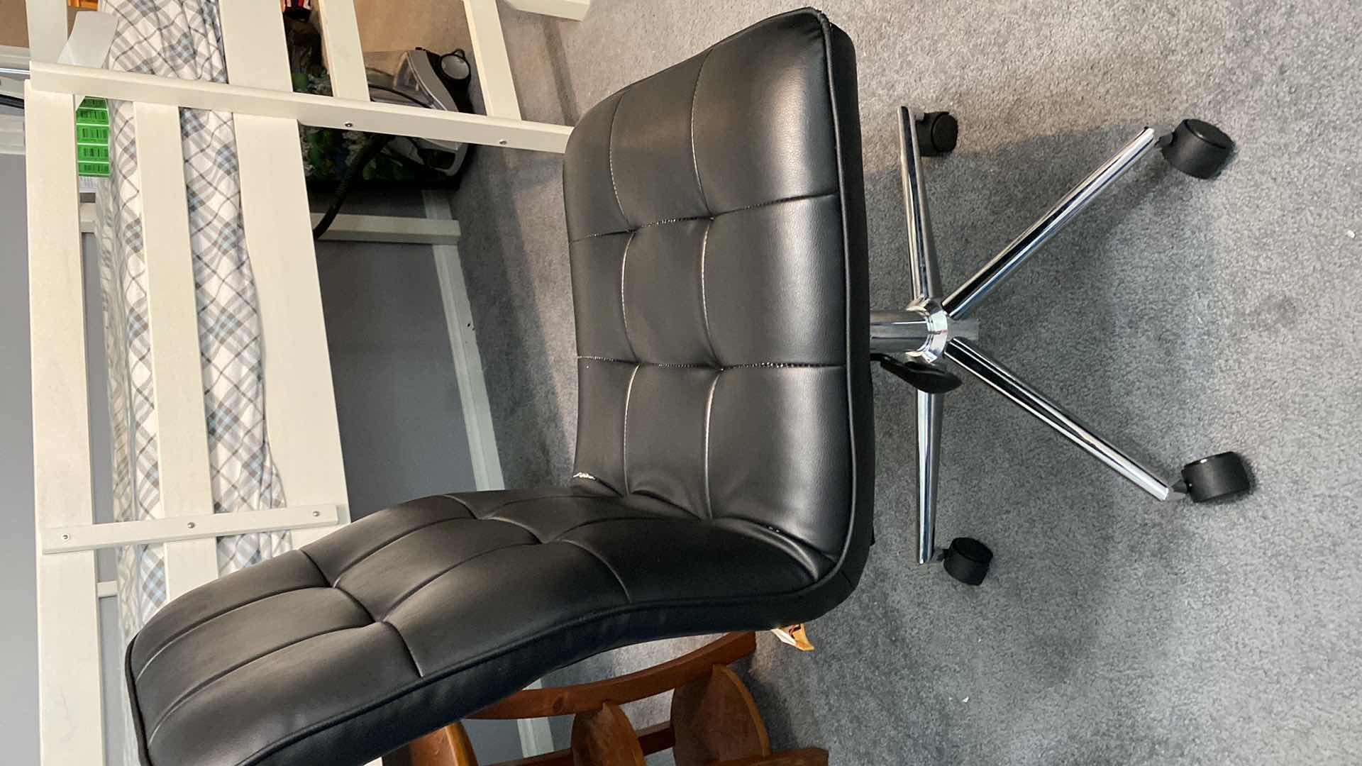 Photo 1 of BLACK FAUX LEATHER ARMLESS DESK ROLLING CHAIR