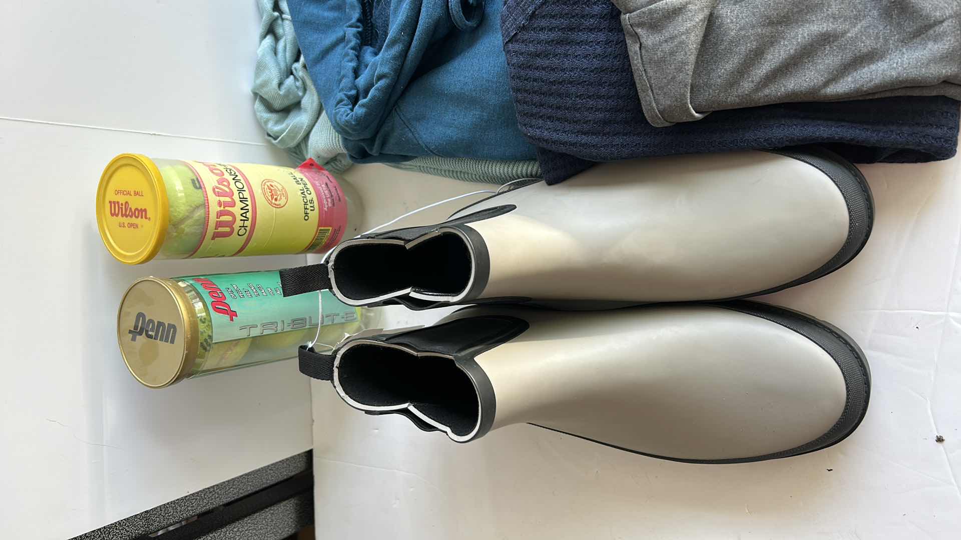 Photo 1 of MENS CLOTHING ASSORTMENT BOOTS AND TENNIS BALLS ( PANTS SHORTS MOSTLY WAIST 38”)