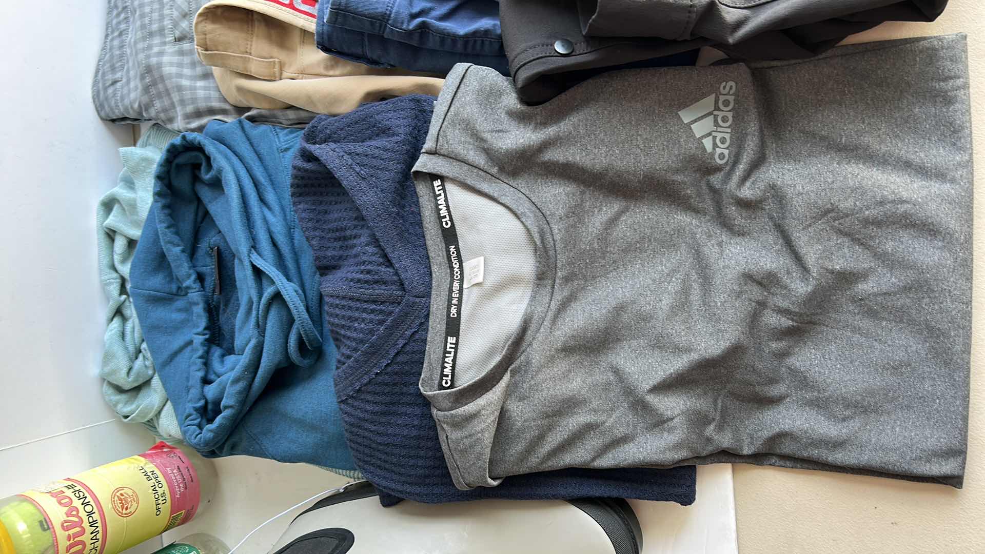 Photo 1 of MENS CLOTHING ASSORTMENT BOOTS AND TENNIS BALLS ( PANTS SHORTS MOSTLY WAIST 38”)