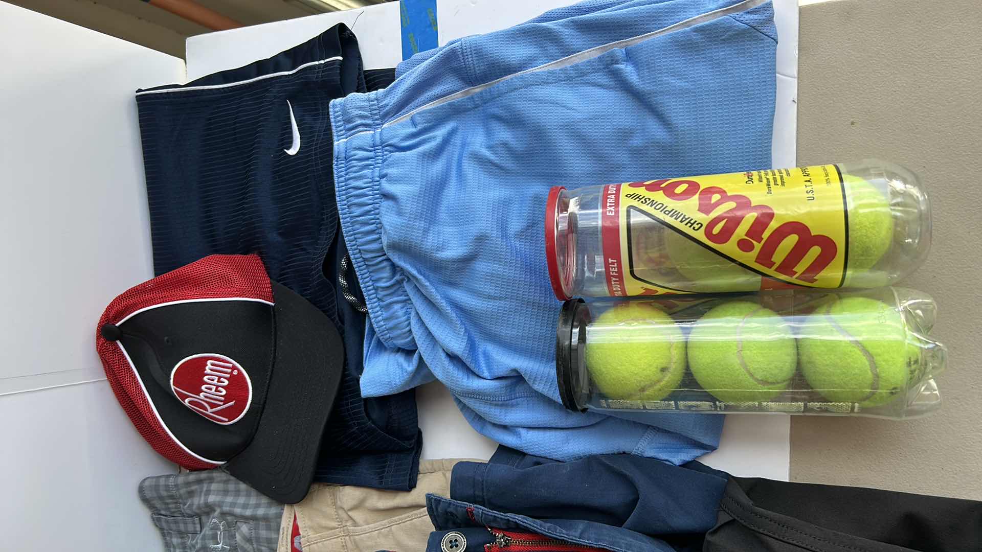 Photo 1 of MENS CLOTHING ASSORTMENT BOOTS AND TENNIS BALLS ( PANTS SHORTS MOSTLY WAIST 38”)