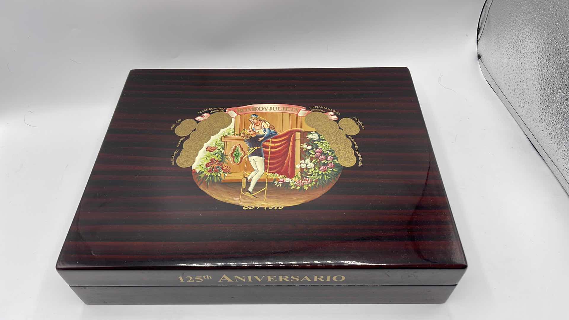 Photo 1 of VINTAGE LACQUERED WOODEN CIGAR HUMIDOR 125th ANNIVERSARY ROMEO AND JULIET 12” X 10” H 2.5”
