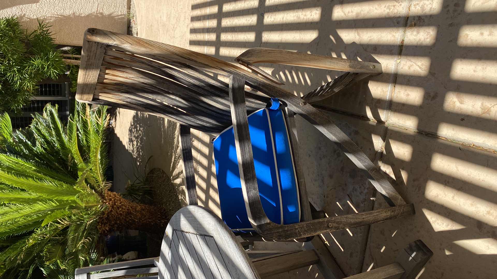 Photo 1 of TEAK WAREHOUSE DINING SET WITH 4 CHAIRS MARINE BLUE WATER REPELLANT AND SUN PROTECTION FABRIC AND POTTED PLANT - TABLE 43” H29” 