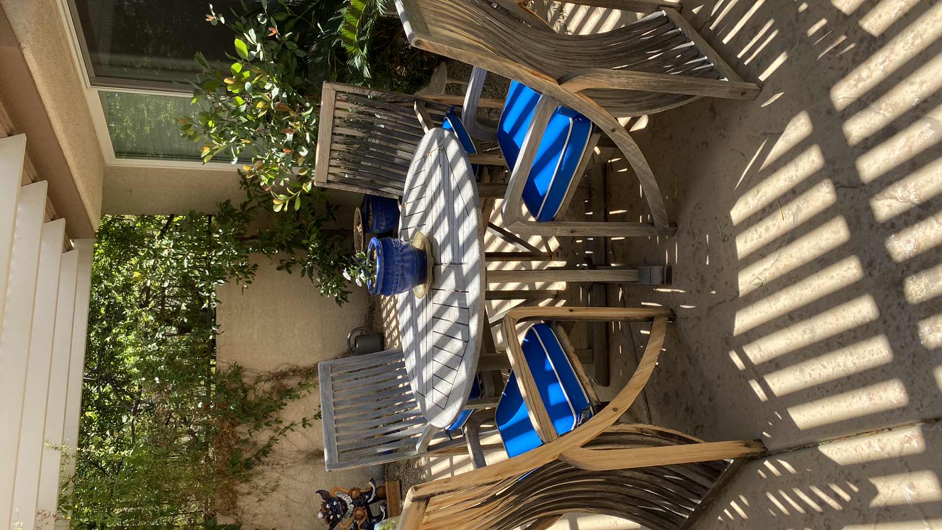 Photo 1 of TEAK WAREHOUSE DINING SET WITH 4 CHAIRS MARINE BLUE WATER REPELLANT AND SUN PROTECTION FABRIC AND POTTED PLANT - TABLE 43” H29” 