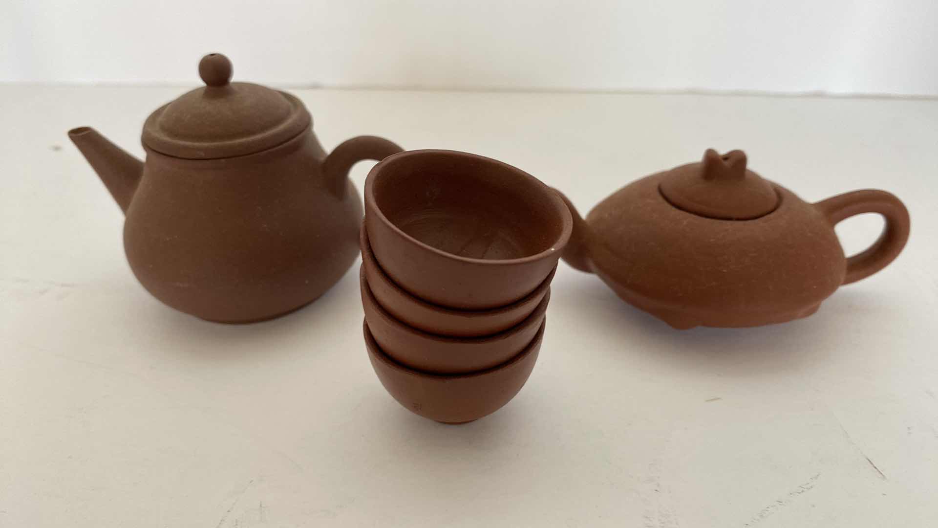 Photo 1 of PAIR OF VINTAGE CHINESE COLLECTIBLE CLAY TEA POTS WITH 4 TEA CUPS LARGEST TEAPOT 4” x 1 1/2”