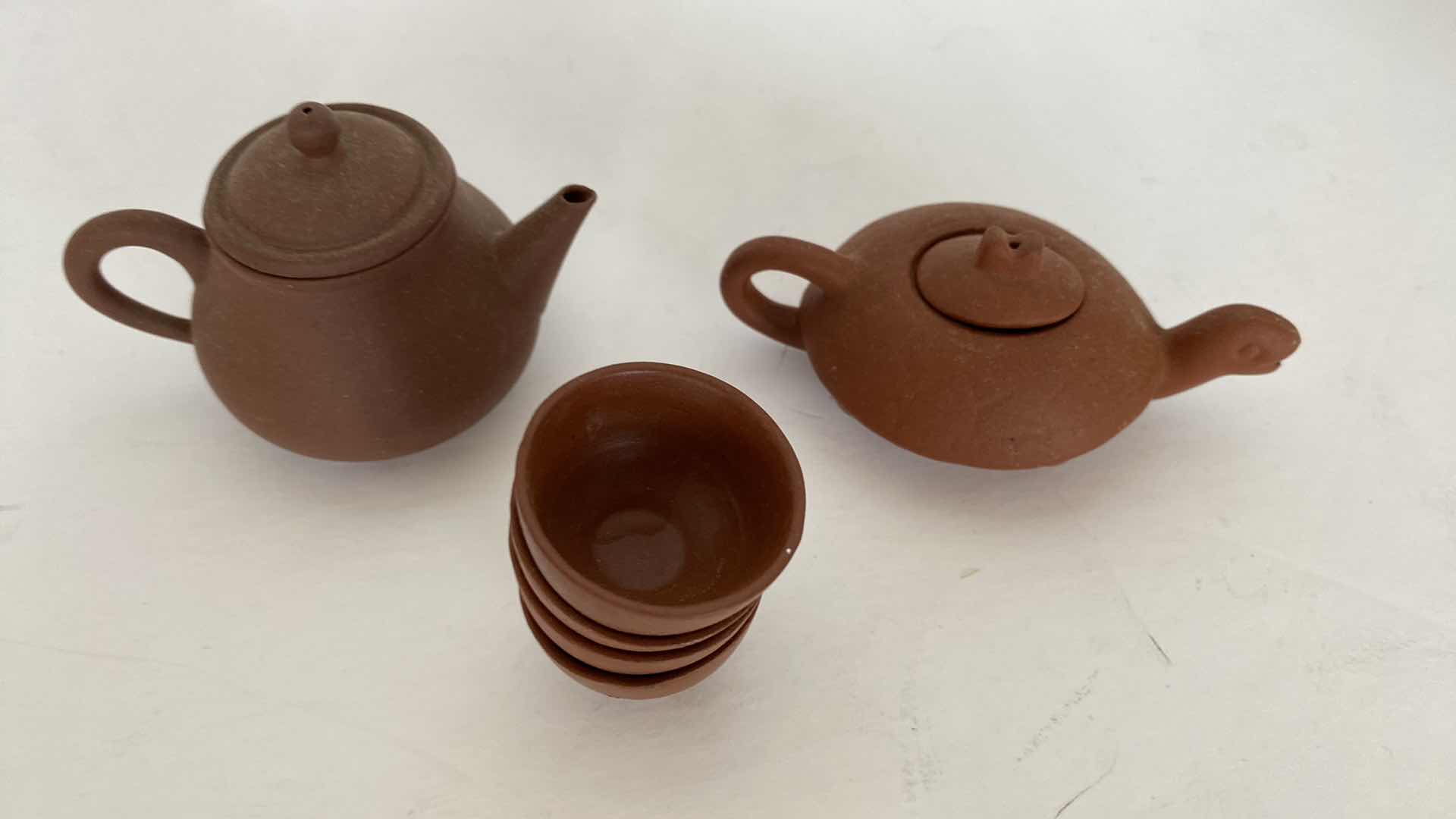 Photo 1 of PAIR OF VINTAGE CHINESE COLLECTIBLE CLAY TEA POTS WITH 4 TEA CUPS LARGEST TEAPOT 4” x 1 1/2”