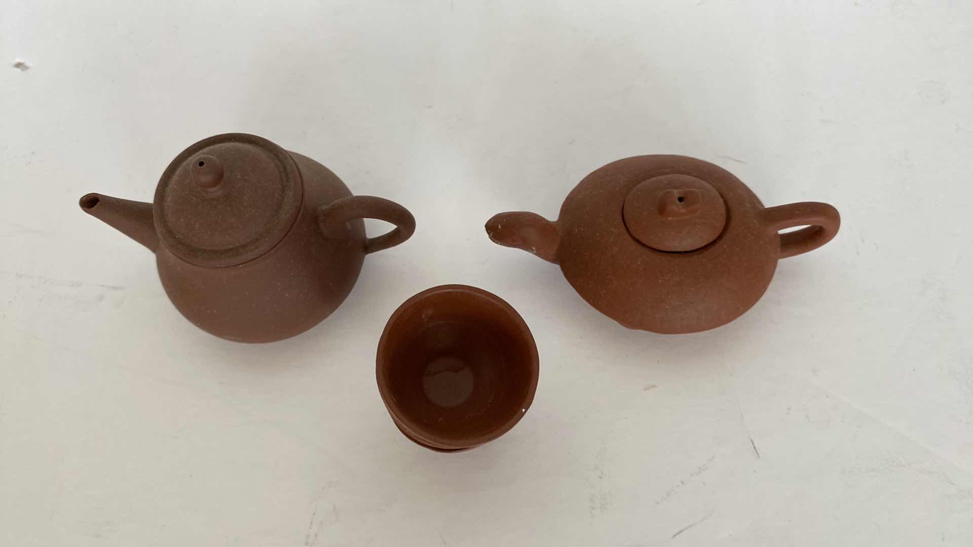 Photo 1 of PAIR OF VINTAGE CHINESE COLLECTIBLE CLAY TEA POTS WITH 4 TEA CUPS LARGEST TEAPOT 4” x 1 1/2”