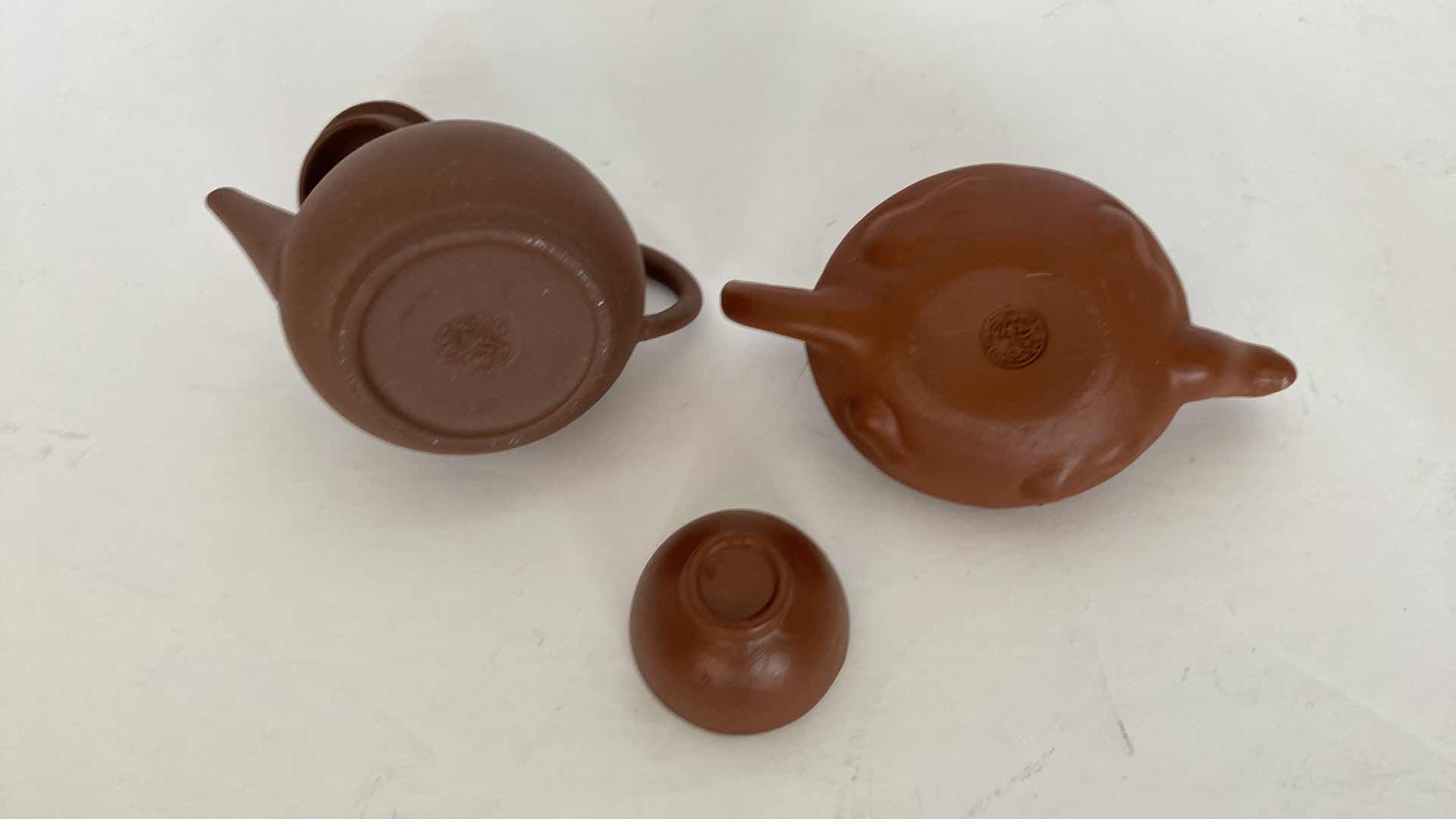 Photo 1 of PAIR OF VINTAGE CHINESE COLLECTIBLE CLAY TEA POTS WITH 4 TEA CUPS LARGEST TEAPOT 4” x 1 1/2”