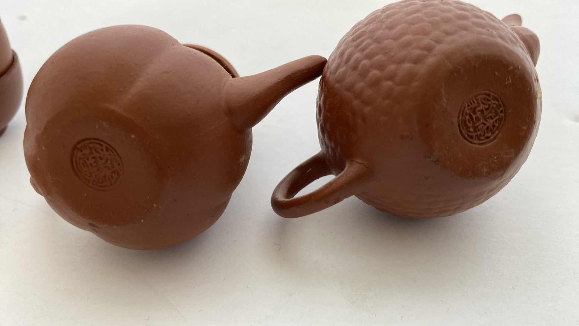 Photo 1 of PAIR OF VINTAGE CHINESE COLLECTIBLE CLAY TEA POTS WITH 4 TEA CUPS LARGEST TEAPOT 3” x 2”