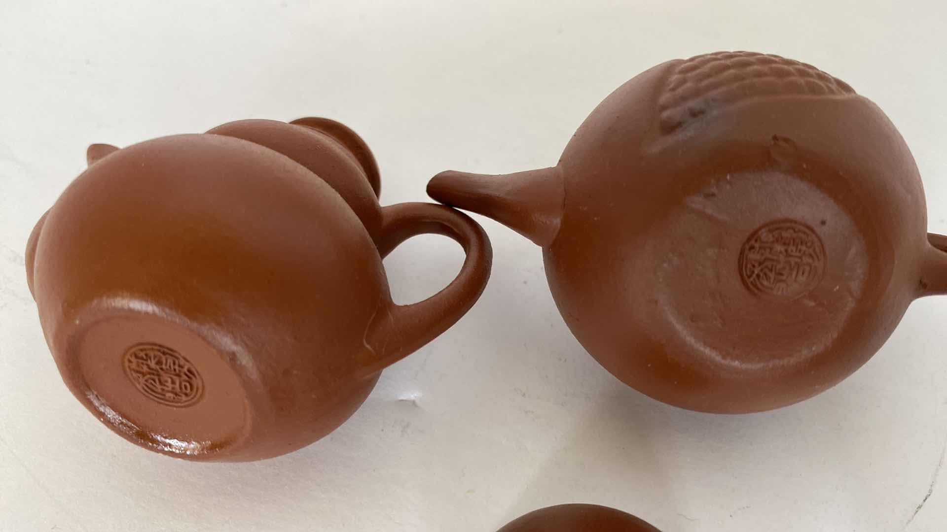 Photo 1 of PAIR OF VINTAGE CHINESE COLLECTIBLE CLAY TEA POTS WITH 4 TEA CUPS LARGEST TEAPOT 3 1/4” x 1 3/4”