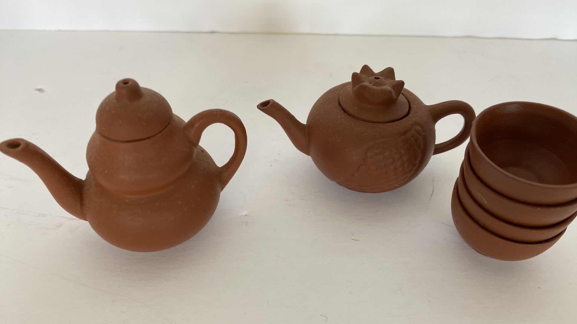 Photo 1 of PAIR OF VINTAGE CHINESE COLLECTIBLE CLAY TEA POTS WITH 4 TEA CUPS LARGEST TEAPOT 3 1/4” x 1 3/4”