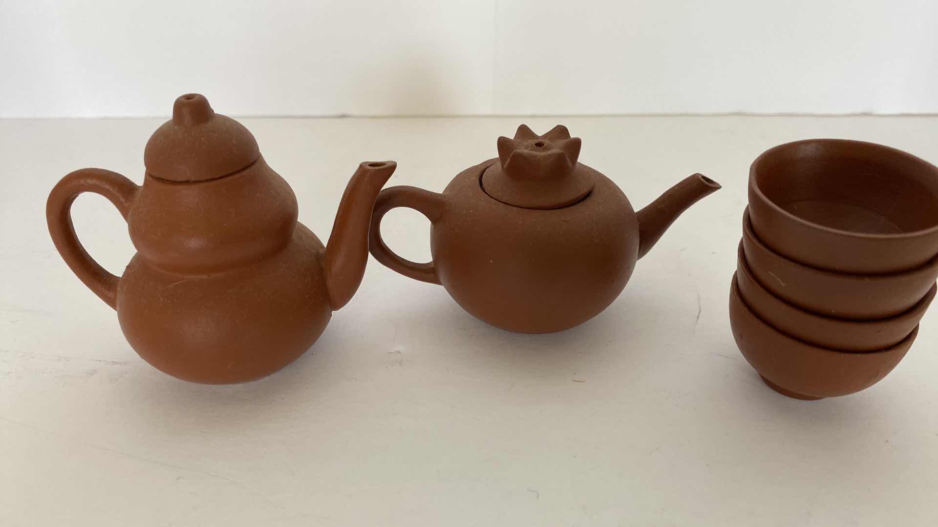 Photo 1 of PAIR OF VINTAGE CHINESE COLLECTIBLE CLAY TEA POTS WITH 4 TEA CUPS LARGEST TEAPOT 3 1/4” x 1 3/4”