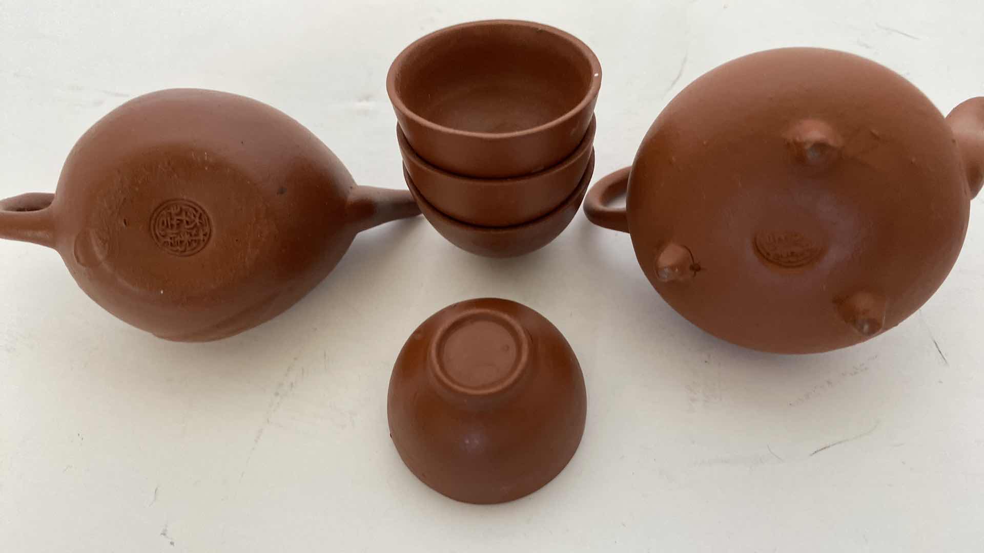 Photo 1 of PAIR OF VINTAGE CHINESE COLLECTIBLE CLAY TEA POTS WITH 4 TEA CUPS LARGEST TEAPOT 3” x 2.25”.