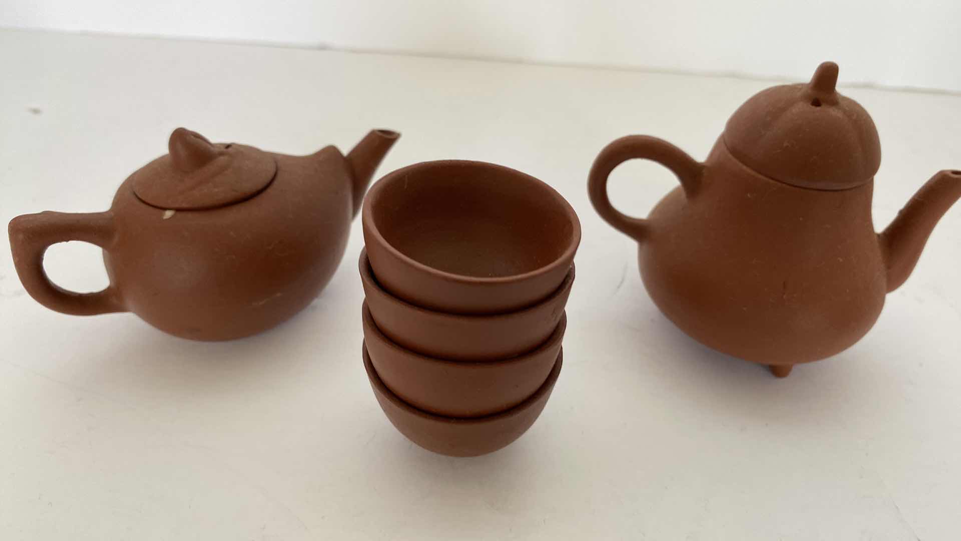 Photo 1 of PAIR OF VINTAGE CHINESE COLLECTIBLE CLAY TEA POTS WITH 4 TEA CUPS LARGEST TEAPOT 3” x 2.25”.
