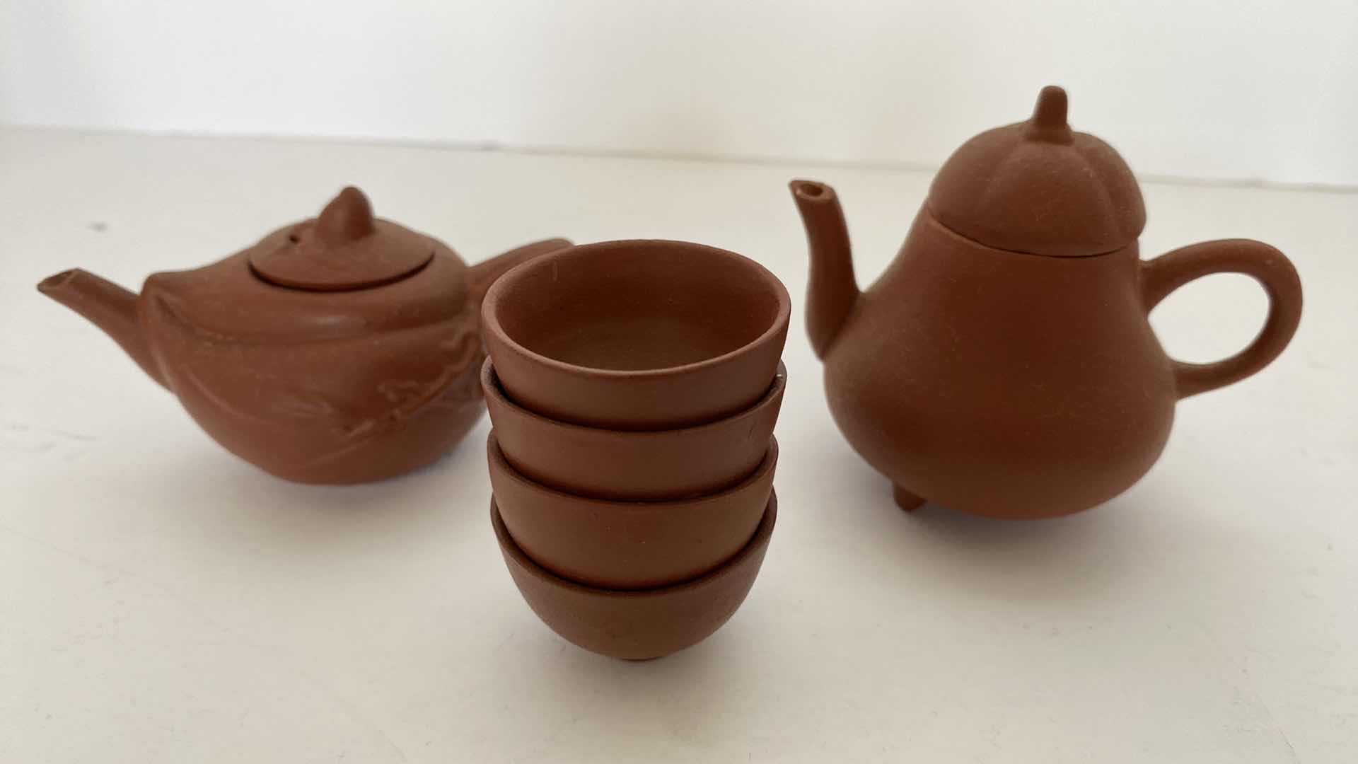 Photo 1 of PAIR OF VINTAGE CHINESE COLLECTIBLE CLAY TEA POTS WITH 4 TEA CUPS LARGEST TEAPOT 3” x 2.25”.