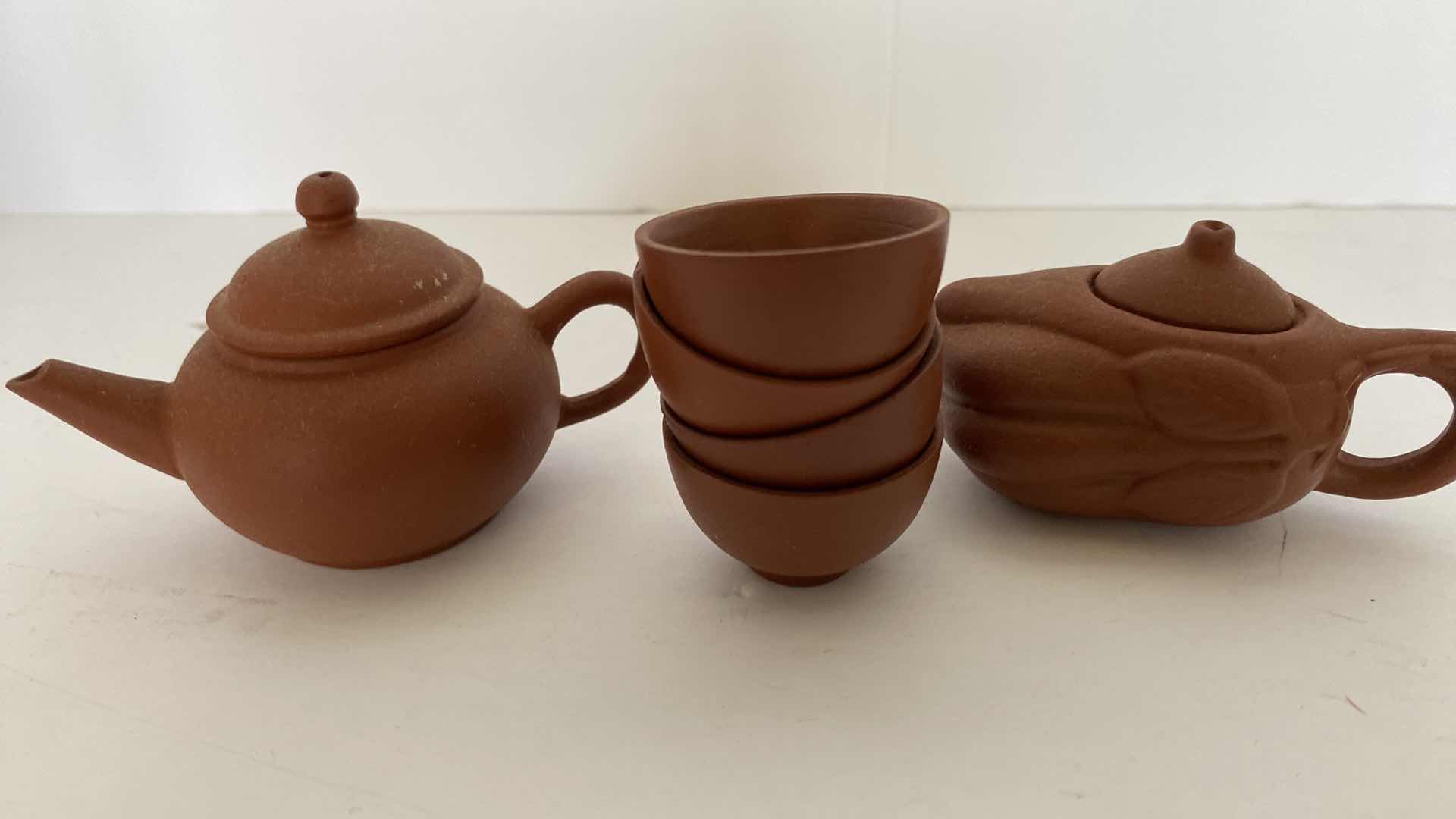 Photo 1 of PAIR OF VINTAGE CHINESE COLLECTIBLE CLAY TEA POTS WITH 4 TEA CUPS LARGEST TEAPOT 3” x 1 7/8”