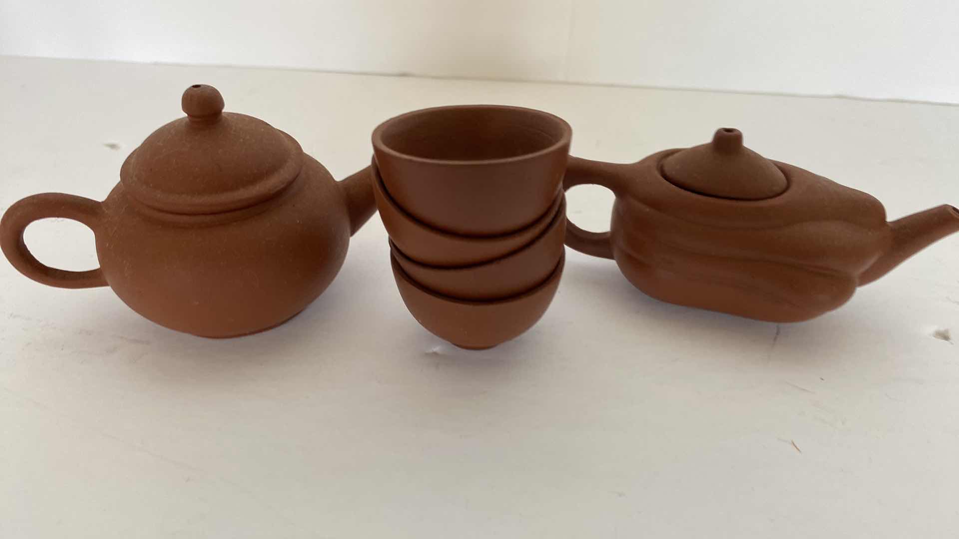 Photo 1 of PAIR OF VINTAGE CHINESE COLLECTIBLE CLAY TEA POTS WITH 4 TEA CUPS LARGEST TEAPOT 3” x 1 7/8”