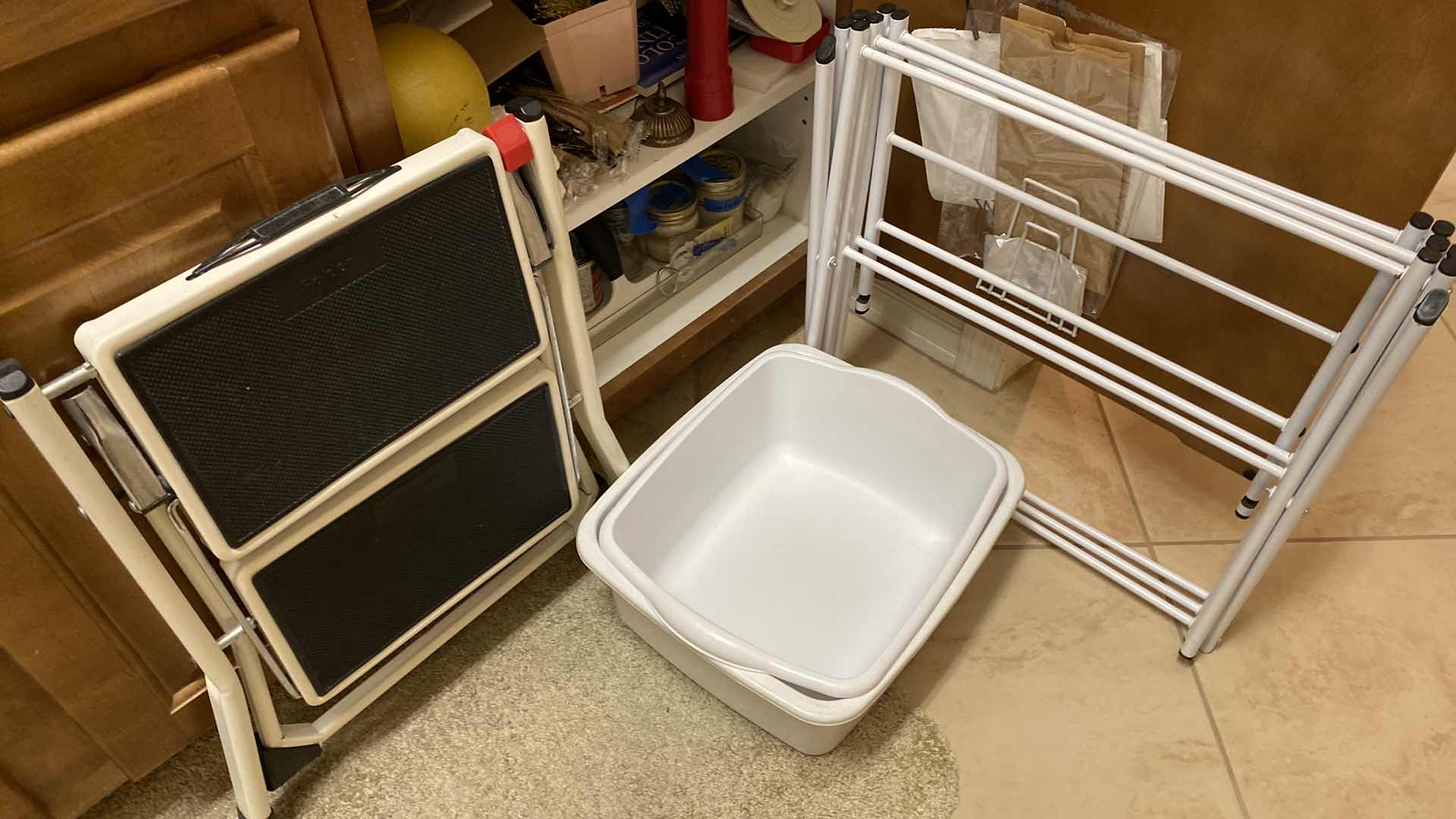 Photo 2 of CONTENTS OF CABINET LAUNDRY ROOM CABINET AND CLOTHES DRYING RACK STEP STOOL AND PLASTIC CONTAINERS