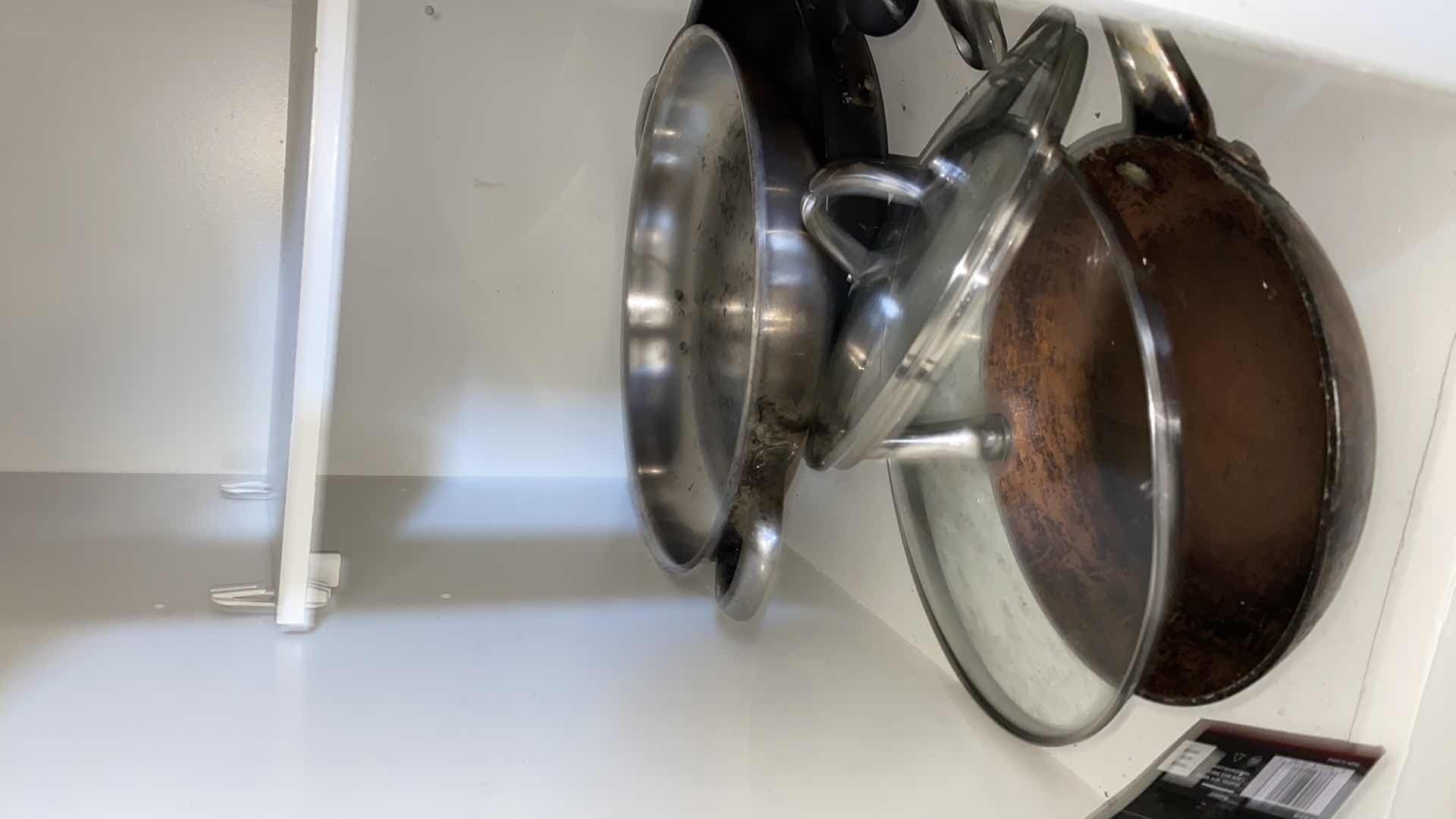 Photo 2 of CONTENTS OF KITCHEN CABINET POTS AND PANS