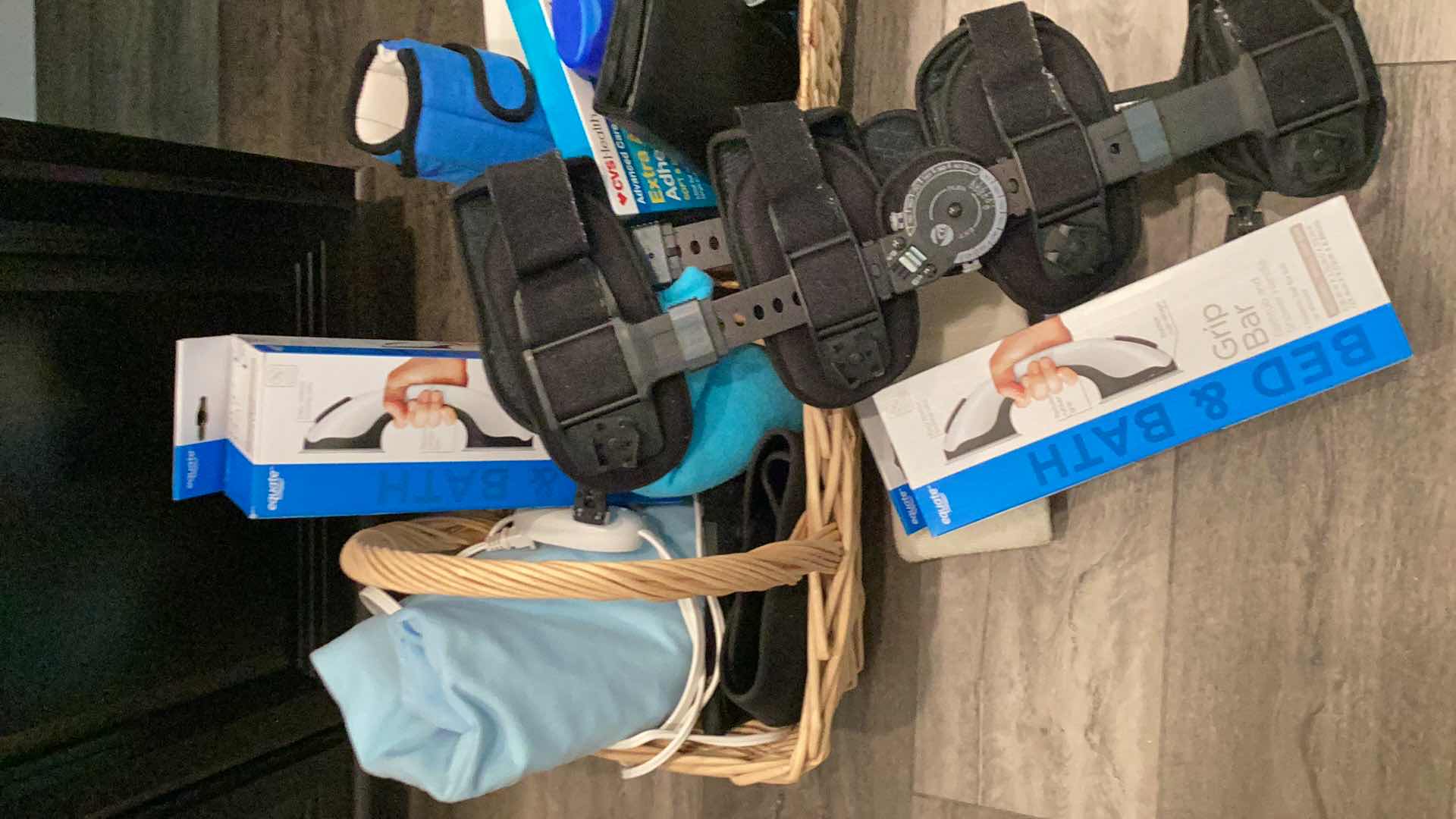 Photo 1 of PERSONAL MEDICAL SUPPLIES INCLUDING BRACES, GRIP BARS, HEATING PAD, BANDAGES, AND SOAP.