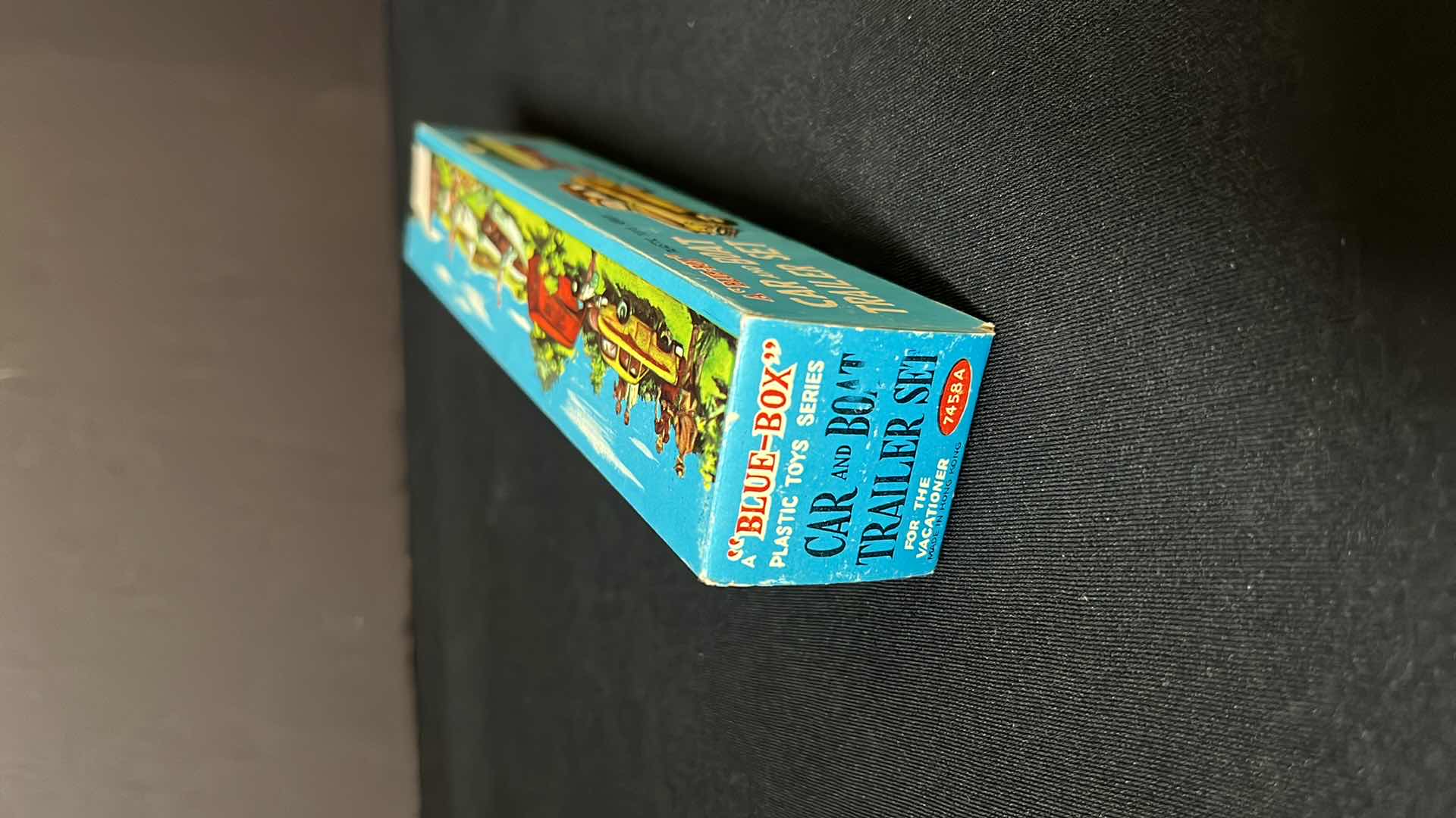 Photo 1 of A BLUE BOX PLASTIC TOY SERIES CAR AND BOAT TRAILER SET, FOR THE VACATIONER