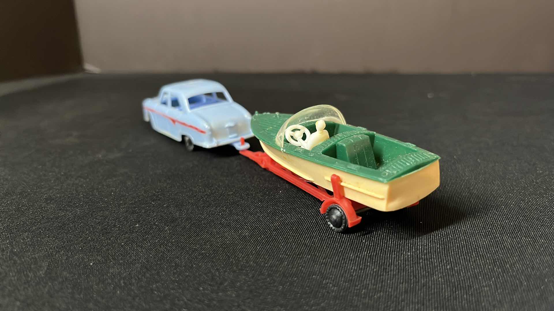 Photo 1 of A BLUE BOX PLASTIC TOY SERIES CAR AND BOAT TRAILER SET, FOR THE VACATIONER