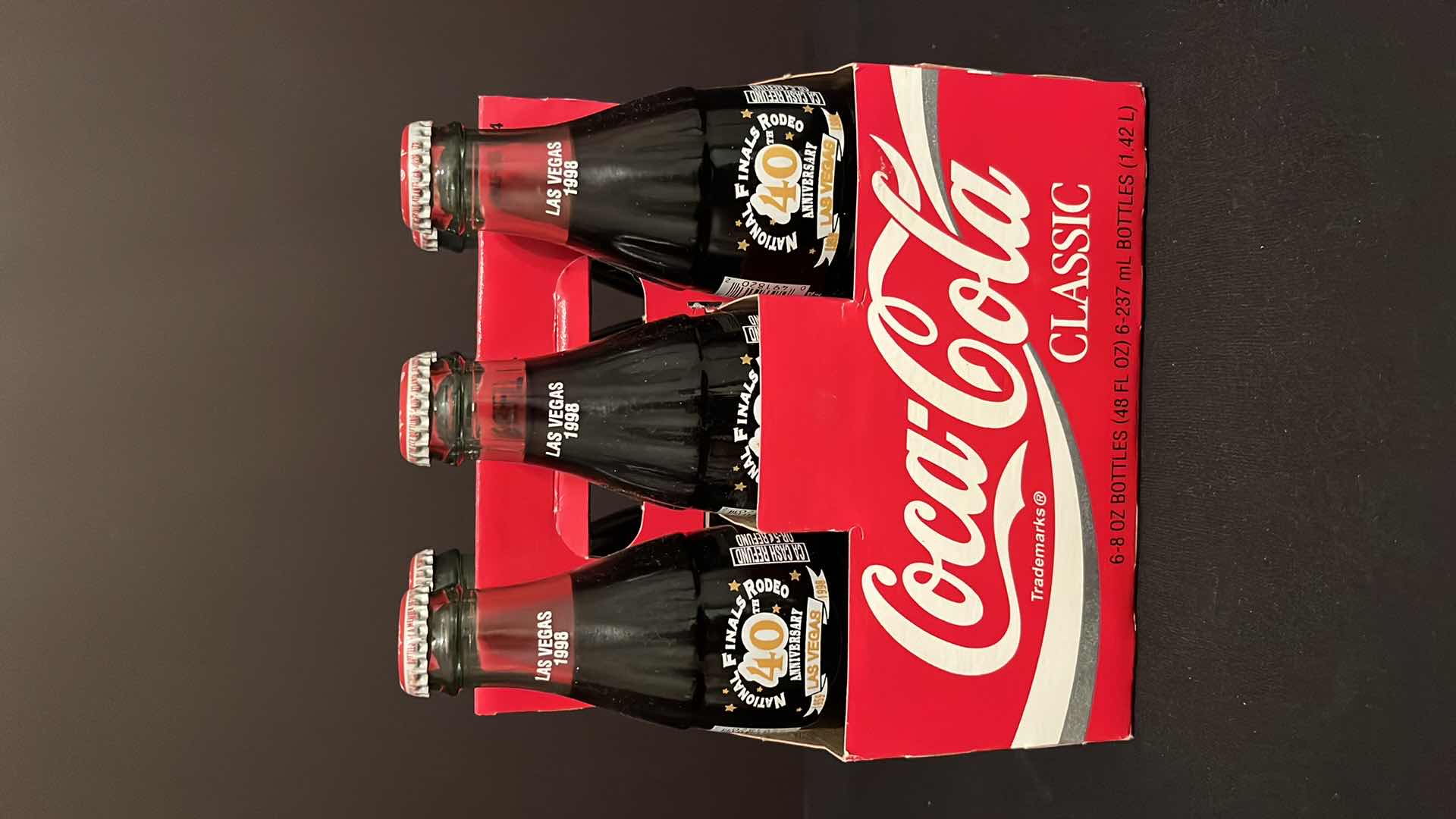 Photo 1 of COCA-COLA COMMEMORATIVE 6-PACK 8 OZ BOTTLES NATIONAL FINALS RODEO 40TH ANNIVERSARY LAS VEGAS UNOPENED, 1998