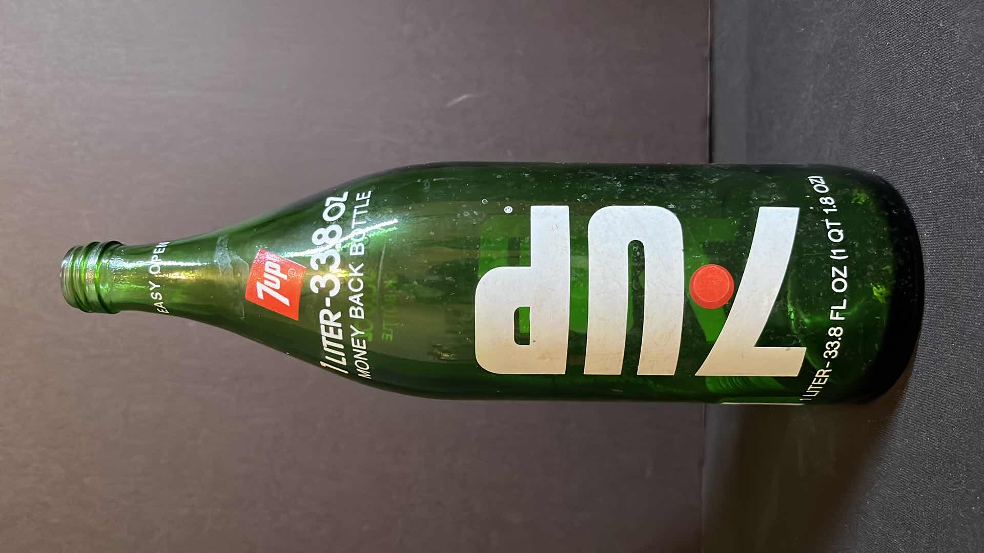 Photo 1 of VINTAGE 2-1970’S GREEN GLASS BOTTLES OF 7-UP RED DOT EDITION, 28 FL OZ & 1 LITER, EMPTY W NO CAPS